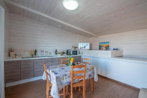a kitchen with a table and chairs in a room at Villa Barnaba Country House & Pool in Polignano a Mare