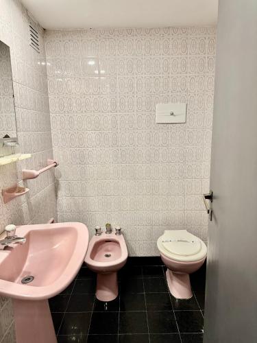 a bathroom with a pink sink and a toilet at Hotel Hey U in Santa Fe