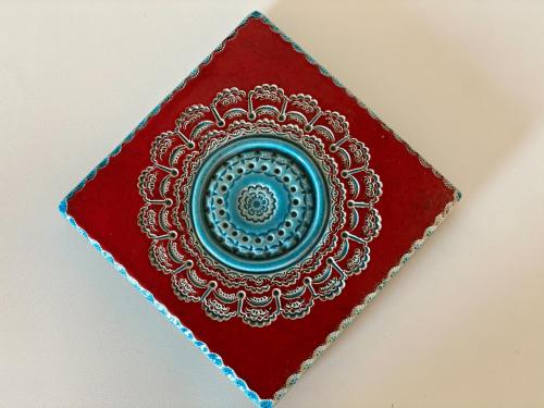 a red book with a blue plate on it at Villa Barnaba Country House & Pool in Polignano a Mare