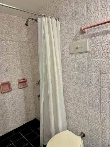 a bathroom with a shower curtain and a toilet at Hotel Hey U in Santa Fe