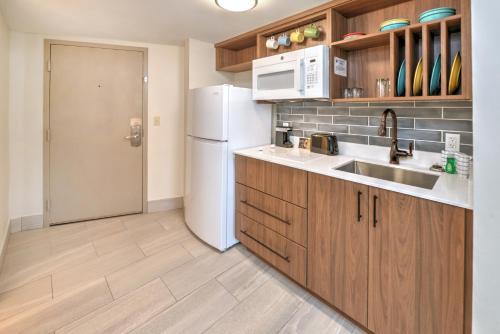 a kitchen with a sink and a white refrigerator at Bahama House - Daytona Beach Shores in Daytona Beach