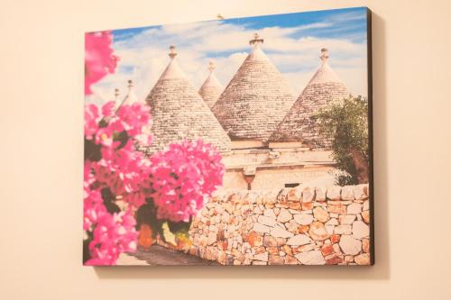 a picture of a castle with pink flowers at Le Stanze di Maria-Ingresso Autonomo Maria's Rooms-Indipendent Entrance in Giovinazzo