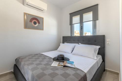 a bedroom with a bed with a hat on it at Casa Aelia ,Stelida Naxos in Stelida