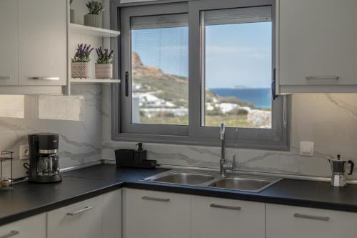 a kitchen with a sink and a window at Casa Aelia ,Stelida Naxos in Stelida