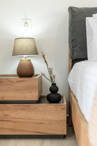 a bed with a lamp on a night stand next to a bed at Casa Aelia ,Stelida Naxos in Stelida
