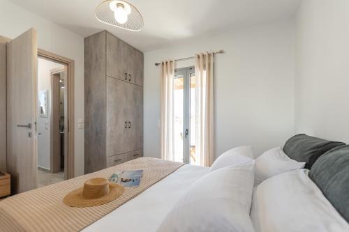 a bedroom with a bed with a hat on it at Casa Aelia ,Stelida Naxos in Stelida