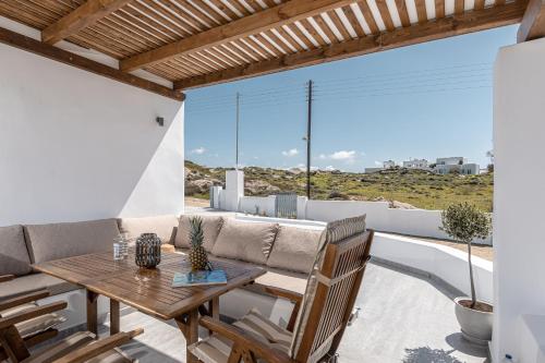 a patio with a table and chairs and a couch at Casa Aelia ,Stelida Naxos in Stelida