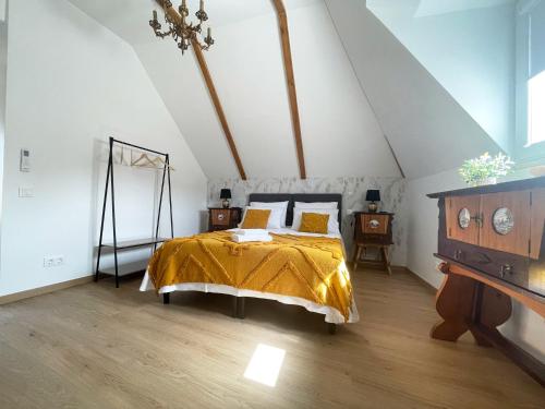 a bedroom with a bed with a yellow comforter at Baia do Mundo in Setúbal