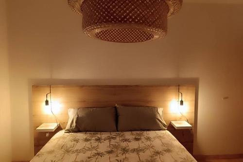 a bedroom with a bed with two night stands and two lamps at Casa Vilas, Santiago de Compostela in Santiago de Compostela