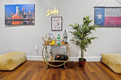 a drink cart in a living room with a plant at Stay Awhile! Pool Table+ Fire-pit+ 4 bedroom+ 2 baths+ Game-room! in Dallas