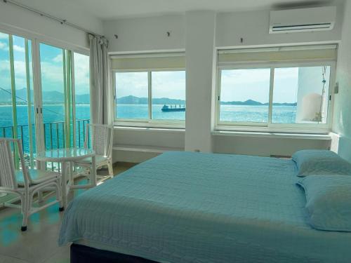 a bedroom with a bed and a view of the ocean at Condo in Puerto las Hadas in Manzanillo
