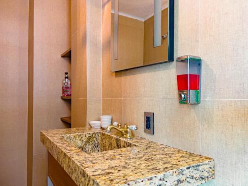a bathroom counter with a sink and a mirror at Condo in Puerto las Hadas in Manzanillo
