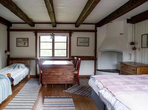 a bedroom with two beds and a desk and a window at STF Tivedstorp in Tivedstorp