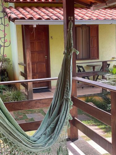 a hammock in front of a house at Pousada Licuri in Serra do Cipo