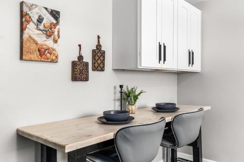 a dining room table with chairs and white cabinets at Warm & Comfy 2BR, Huge Backyard, Great Location! in Shelby