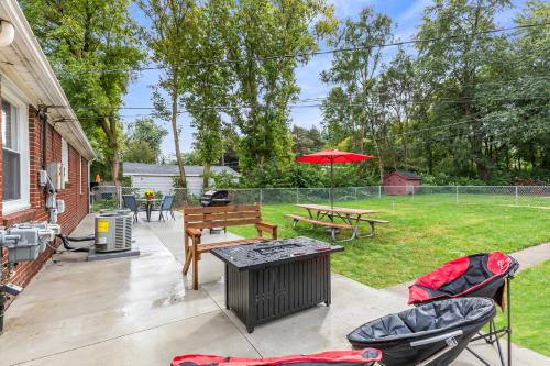 a patio with a table and chairs and an umbrella at Warm & Comfy 2BR, Huge Backyard, Great Location! in Shelby
