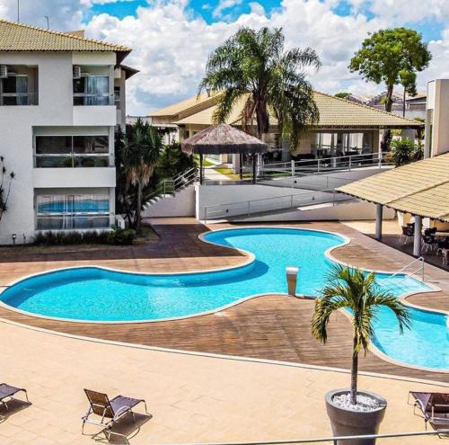 a large swimming pool in front of a building at Hotel BHS in Linhares