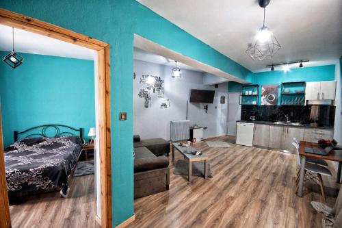 a bedroom with a bed and a living room at Urban Apartment Kastoria in Kastoria