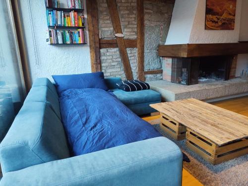 a living room with a blue couch and a table at Central-city Penthouse in Bern