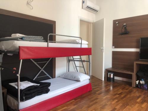 a room with two bunk beds and a television at Grand Cucinetta in Rome