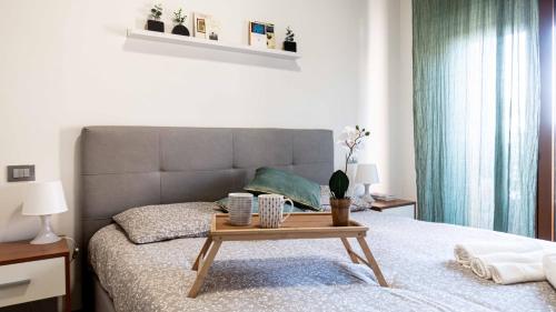 a bedroom with a bed with a table on it at Casa vacanze Il Cammino Assisi in Assisi