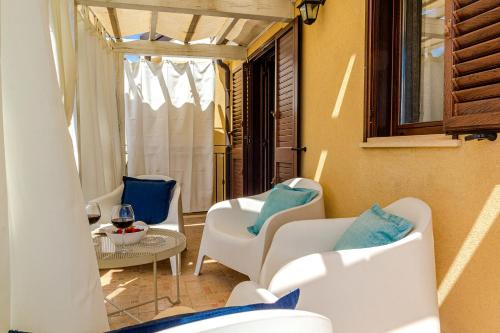 a room with chairs and a table and a window at Villetta Desiderio Apartment in Giardini Naxos