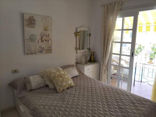 a bedroom with a bed and a sliding glass door at Maison en duplex & rooftop in Callao Salvaje