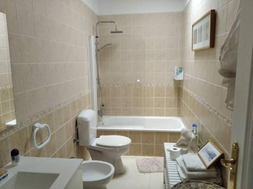 a bathroom with a toilet and a bath tub at Maison en duplex & rooftop in Callao Salvaje
