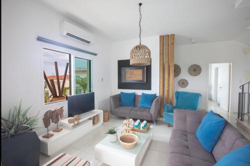 a living room with a couch and a tv at Romeo & Juliet in Protaras