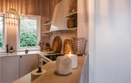 a kitchen with a candle on top of a counter at Gorgeous Home In Sydals With Wifi in Skovby