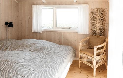 a bedroom with a bed and a chair and a window at Beautiful Home In Sydals With 4 Bedrooms, Sauna And Wifi in Skovby