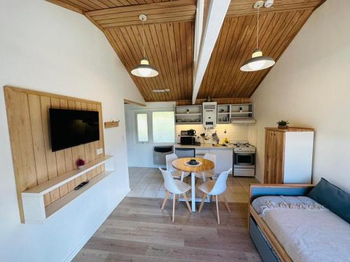 a kitchen and living room with a table and a couch at Gi´s House 4Pax in Ushuaia