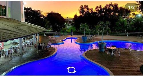 a large pool with blue water in a resort at Hotel BHS in Linhares