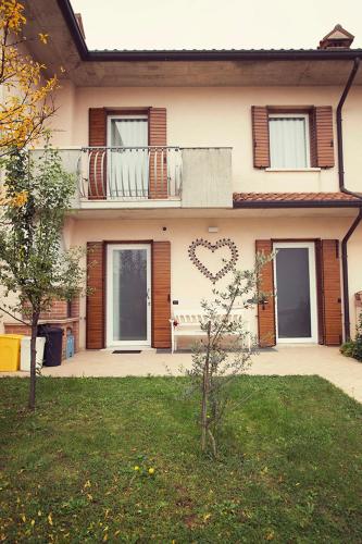 a house with a heart painted on the side of it at Cozy apartment in Romano D'ezzelino 45 m² with secured garden in Romano D'Ezzelino