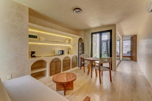 a kitchen and dining room with a table and chairs at Eterna Tulum in Tulum