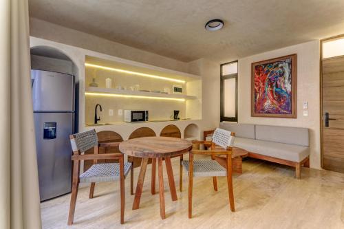 a kitchen and dining room with a table and chairs at Eterna Tulum in Tulum