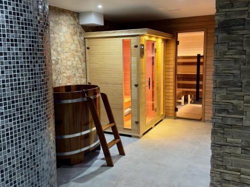 a room with a barrel and a wooden door at Chata Tale - Dom Horskej služby in Tale