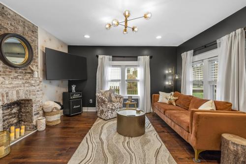 a living room with a couch and a fireplace at Space Cowboy - Huge yard, Firepit, close2downtown in Nashville