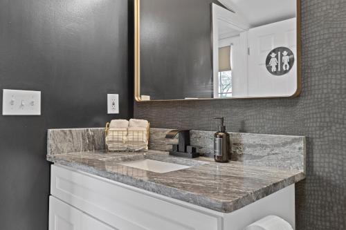 a bathroom with a sink and a mirror at Space Cowboy - Huge yard, Firepit, close2downtown in Nashville