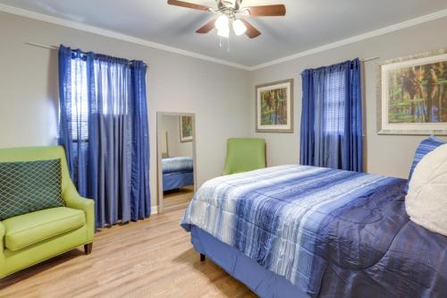 a bedroom with a bed and a fan and a chair at Cozy and Convenient Macon Home about 3 Mi to Town! in Macon