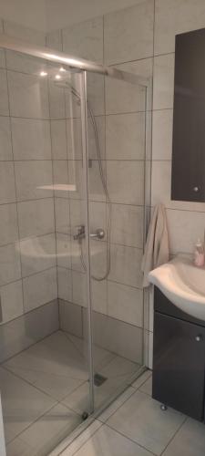 a shower with a glass door next to a sink at Kiti Village Villa Larnaca, salt-water pool, 5 bedrooms in Kiti