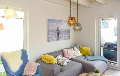 a living room with a couch and a picture on the wall at Lovely Home In Büsum Nordsee Ressort in Büsum