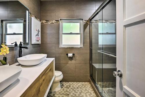 a bathroom with a toilet and a sink and a shower at Charming Temple City Home with Fire Pit, 14 Mi to LA in Temple City