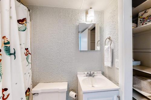 a bathroom with a sink and a toilet and a mirror at Sea Mark 208 in Ocean City