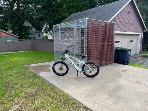 a bike parked in a cage in a yard at Berrodin Bed & Breakfast in Akron