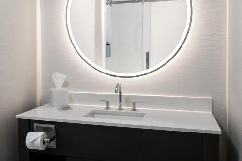 a bathroom with a sink and a mirror at Courtyard by Marriott Houston Kemah in Kemah