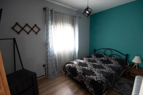 a bedroom with a bed and a large window at Urban Apartment Kastoria in Kastoria