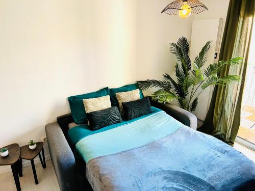 a couch with pillows on it in a living room at LE PRADO - Spacieux studio tout confort sur les hauteurs de Grasse in Grasse