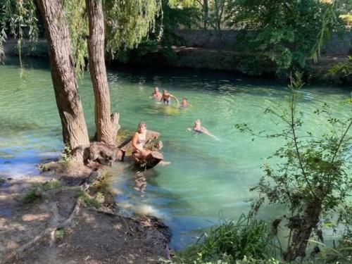 a group of people swimming in a river at Maison Centre Historique Bize Minervois + Terrasse in Bize-Minervois