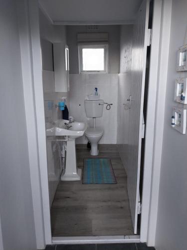 a bathroom with a toilet and a sink at À La Mer - Selfcatering Unit in Agulhas